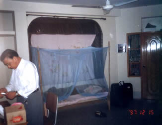 This our bedroom, three men live in a room, put up a mosquito net above the plank bed